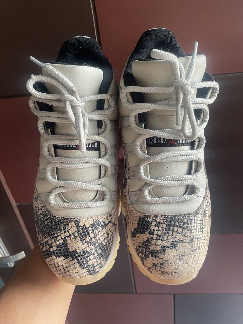 Air Jordan 11 Low Snakeskin (Category: Sneakers) located in Laguindingan. Submitted by kixseven (Listing ID 1439442606, Image 2). Description: Air Jordan 11 Low sneakers with snakeskin detailing. Features a white upper with snakeskin on the toe and heel. The soles are translucent with a red Jumpman logo. The shoes have white laces and a black inner lining. The Jumpman logo is visible on the heel. - No COD ❌ - Location : Mindanao - Ship nationwide