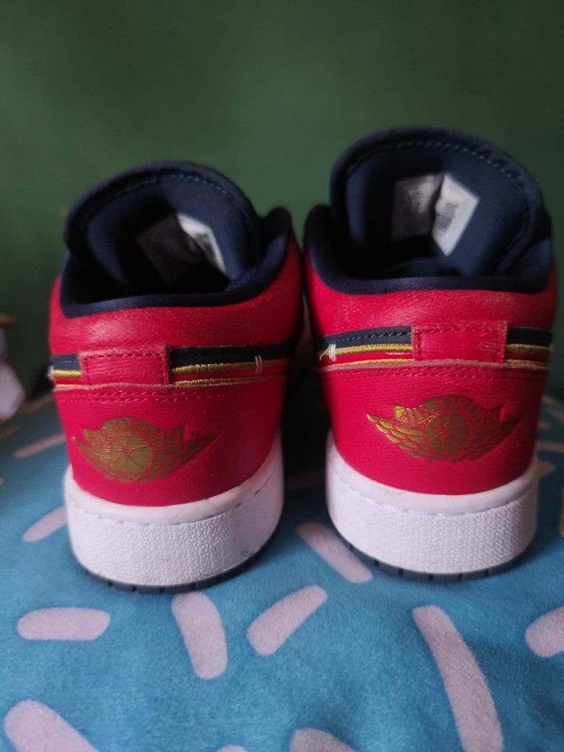 Air Jordan 1 Low GS - Red/Navy (Category: Sneakers) located in Valenzuela. Submitted by janethco2031756 (Listing ID 1439507423, Image 3). Description: - Air Jordan 1 Low GS sneakers - Colorway: Red, Navy, and Gold - Size: US 5.5Y / EUR 38 / CM 24 - Features the Air Jordan logo - White sole - Style Code: FQ7380-400 - Made in Indonesia.