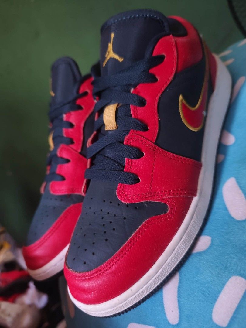 Air Jordan 1 Low GS - Red/Navy (Category: Sneakers) located in Valenzuela. Submitted by janethco2031756 (Listing ID 1439507423, Image 2). Description: - Air Jordan 1 Low GS sneakers - Colorway: Red, Navy, and Gold - Size: US 5.5Y / EUR 38 / CM 24 - Features the Air Jordan logo - White sole - Style Code: FQ7380-400 - Made in Indonesia.