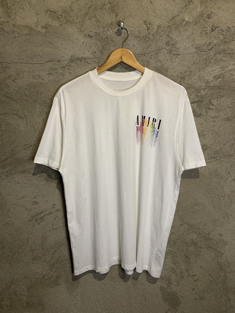 Amiri Rainbow Logo T-shirt (Category: Tshirts & Polo Shirts ) located in Tacurong. Submitted by ljsthrift (Listing ID 1439504755, Image 1). Description: - Amiri T-shirt with rainbow logo design. - Features the Amiri logo on the front and a larger rainbow design on the back. - Back design includes "Designed in California" text. - Size: IT 52 / CN 185/92B. - Material: 100% Cotton..