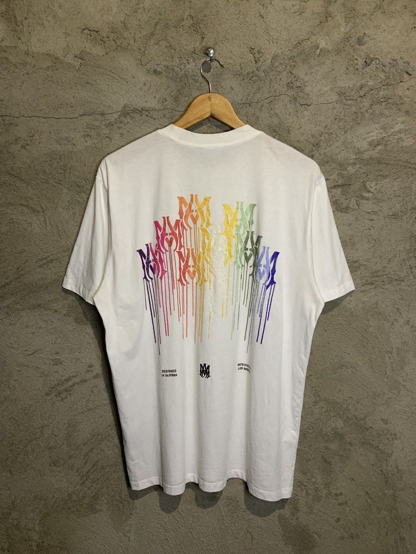 Amiri Rainbow Logo T-shirt (Category: Tshirts & Polo Shirts ) located in Tacurong. Submitted by ljsthrift (Listing ID 1439504755, Image 2). Description: - Amiri T-shirt with rainbow logo design. - Features the Amiri logo on the front and a larger rainbow design on the back. - Back design includes "Designed in California" text. - Size: IT 52 / CN 185/92B. - Material: 100% Cotton..