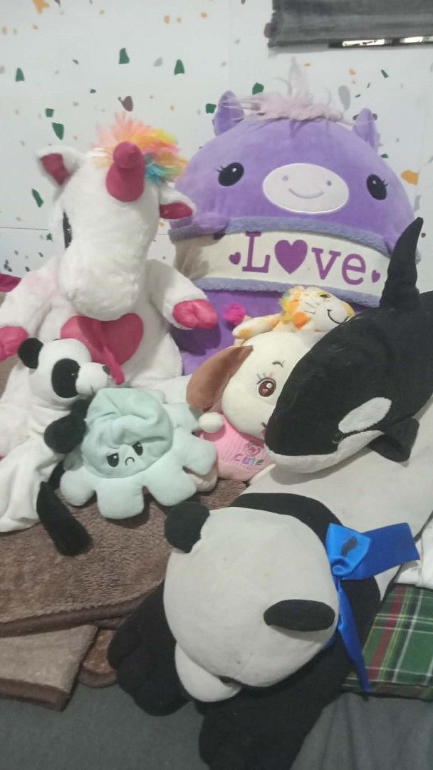 Assorted Plush Toys (Category: Toys & Games) located in Manila. Submitted by wisegem-231b (Listing ID 1439526679, Image 1). Description: - Unicorn with rainbow mane and heart - Purple plush with "LOVE" and heart design - Panda with blue ribbon - Octopus, dog, and orca also included! - Soft and cuddly plushies.