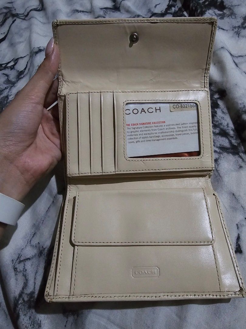 (Authentic) Coach Signature Wallet (Category: Luxury Bags & Wallets) located in Manila. Submitted by cclamb (Listing ID 1439589567, Image 3). Description: - Coach wallet with signature pattern - Multiple card slots - Compartments for cash and essentials - Snap closure - Interior: Light cream color - Exterior: Brown and tan color scheme -Guaranteed authentic with care card - See pics for condition and flaws -RFS: New wallet.
