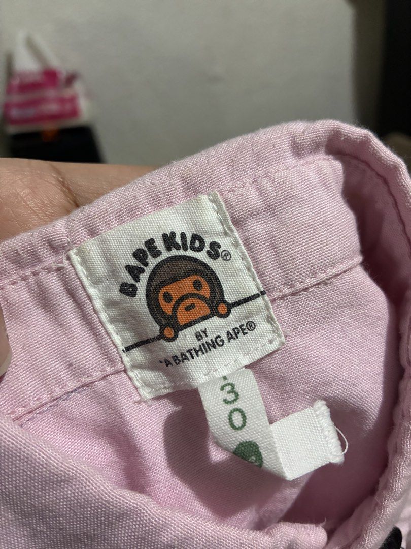 BAPE Kids Pink Argyle Shirt (Category: Babies & Kids Fashion) located in Quezon City. Submitted by grai25 (Listing ID 1439480906, Image 3). Description: - BAPE Kids shirt - Pink body - Argyle pattern chest - Short sleeves - Button-down design - Small BAPE logo on sleeve - BAPE Kids tag on collar.