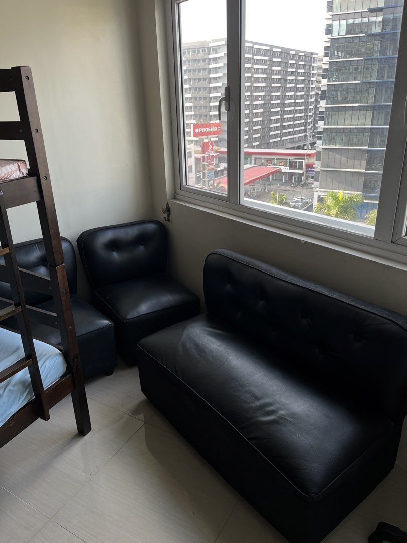 Black Leather Sofa Set (Category: Sofas) located in Manila. Submitted by keshi61 (Listing ID 1439606284, Image 3). Description: - Black leather sofa set - Includes 2-seater sofa and two single chairs - Button detailing on backrests - Modern design - Suitable for living rooms or small spaces.