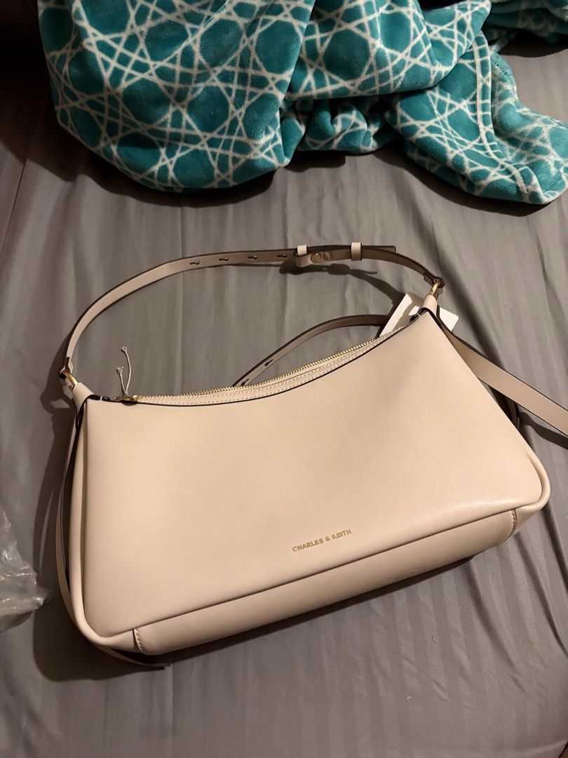 Charles & Keith — Calla Oat (M) (Category: Shoulder Bags) located in Pasay City. Submitted by ydeclutters (Listing ID 1439583415, Image 2). Description: with a very minimal stain sa bottom ng bag (see pics) with paperbag, dustbag and receipt pa has the extender para maging cross body bag bought nung dec 2025 RFS: not using na - used 4-5x only .