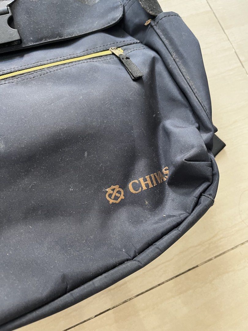 Chivas blue Backpack (Category: Backpacks) located in Manila. Submitted by jiden26 (Listing ID 1439603254, Image 2). Description: - Navy blue backpack with Chivas logo. - Front zipper pocket. - Flap closure with buckle. - Adjustable shoulder straps. - Shows wear and tear. - Includes a tear on the side..