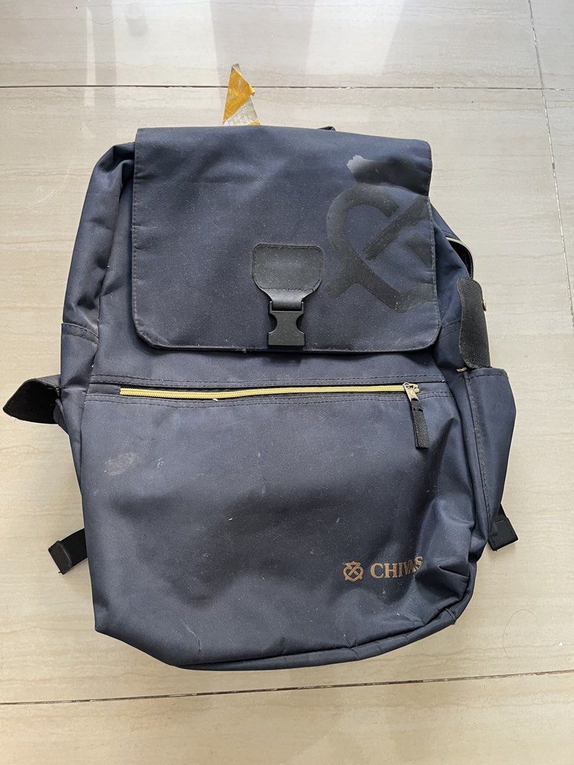 Chivas blue Backpack (Category: Backpacks) located in Manila. Submitted by jiden26 (Listing ID 1439603254, Image 1). Description: - Navy blue backpack with Chivas logo. - Front zipper pocket. - Flap closure with buckle. - Adjustable shoulder straps. - Shows wear and tear. - Includes a tear on the side..