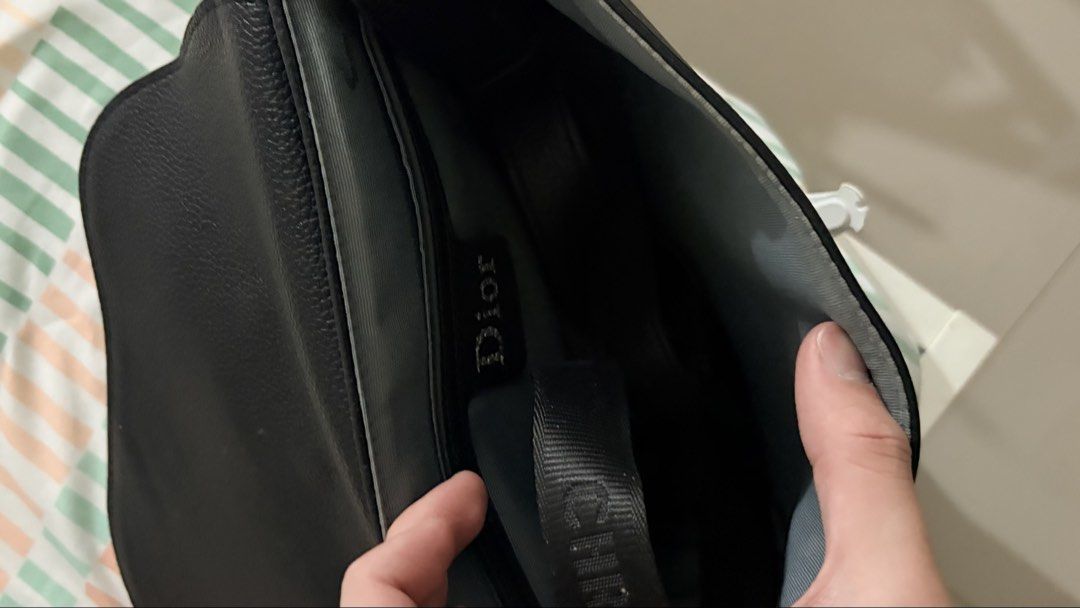 Christian Dior Saddle Bag (Category: Luxury Bags & Wallets) located in Manila. Submitted by rarewhale_9a584c (Listing ID 1439553255, Image 3). Description: - Christian Dior Saddle Bag - Color: Black - Silver-tone buckle closure with Christian Dior logo - Interior Dior label - Single compartment - Condition: Minor wear and tear on the side.