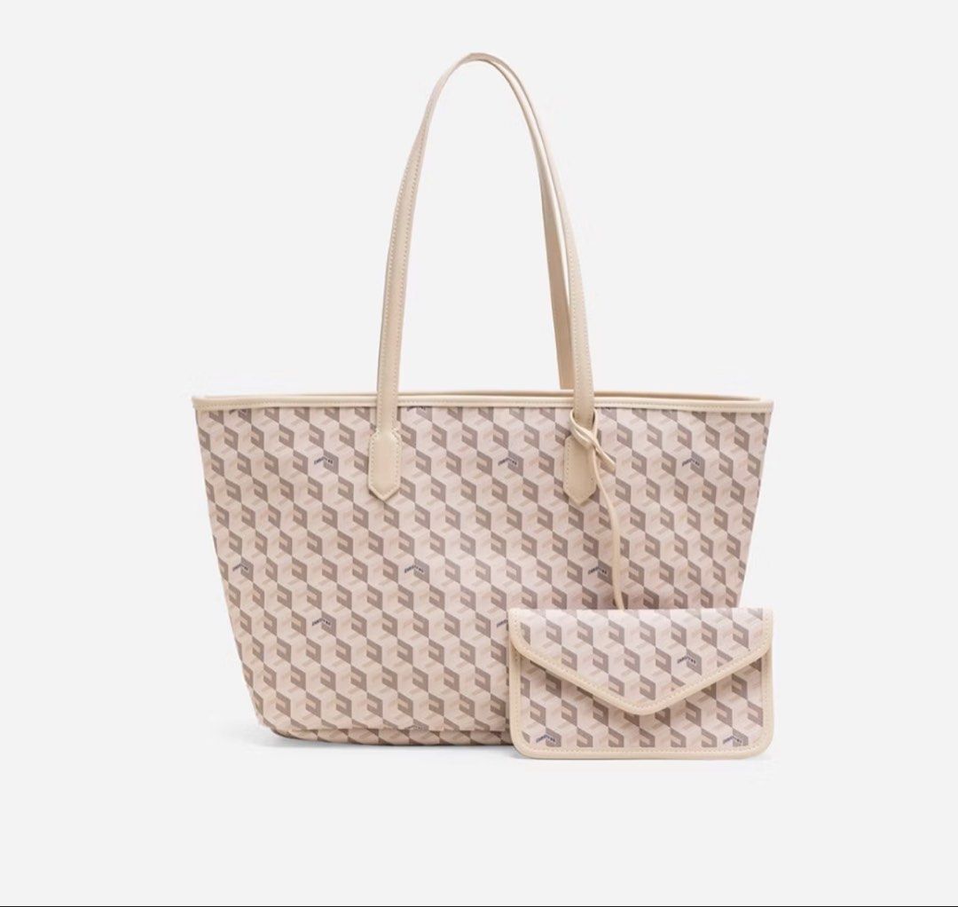 Christy Ng Russo Large Tote Bag (Category: Tote Bags) located in Quezon City. Submitted by lememoir (Listing ID 1439494332, Image 1). Description: - Stylish tote bag with matching pouch - Features a geometric pattern in neutral tones - Long handles for comfortable shoulder carry - Includes a small envelope-style pouch for essentials - Made from a durable material - Ideal for everyday use or as a chic accessory.