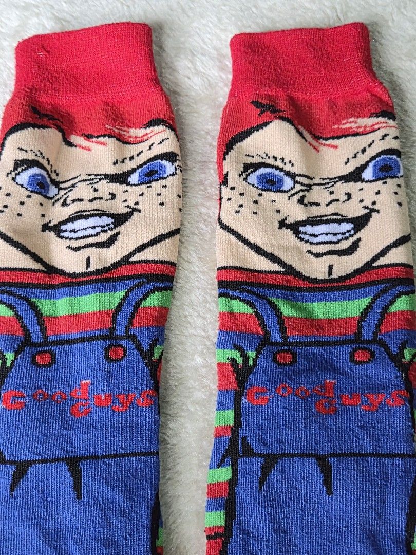 Chucky Socks (Category: Socks) located in Mandaue City. Submitted by chuchi152615 (Listing ID 1439513531, Image 2). Description: - Chucky-themed socks - Features iconic Chucky doll design - Colors: Red, blue, green, and white - Long socks - Includes Chucky's face and overalls design - Red cuff.