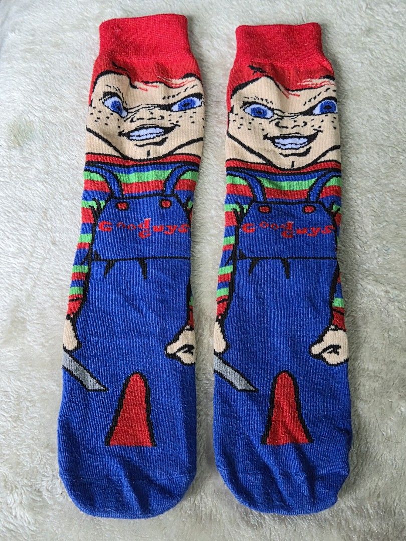 Chucky Socks (Category: Socks) located in Mandaue City. Submitted by chuchi152615 (Listing ID 1439513531, Image 1). Description: - Chucky-themed socks - Features iconic Chucky doll design - Colors: Red, blue, green, and white - Long socks - Includes Chucky's face and overalls design - Red cuff.