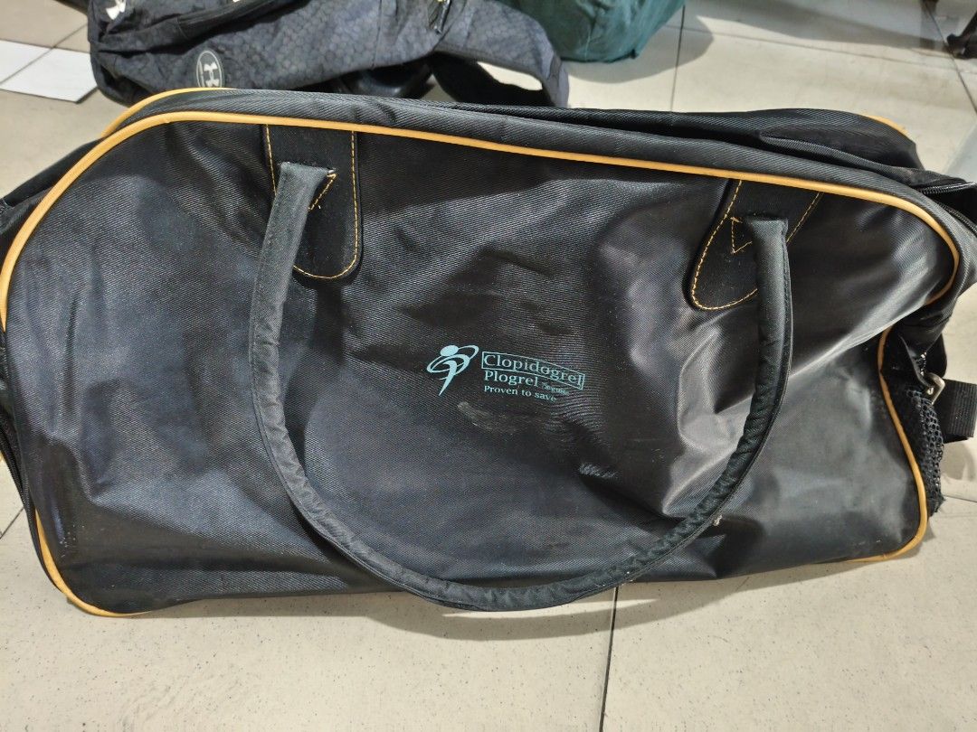 Citicoline Choline Duffle Bag - Black and Yellow (Category: Luxury Bags & Wallets) located in Del Monte. Submitted by anitagalan89774 (Listing ID 1439435895, Image 2). Description: - Black duffle bag - Yellow accents and orange trim - Two handles - Zipper closure - Features Citicoline Choline and Clopidogrel Pharma logos - Spacious interior - Perfect for travel or gym use.