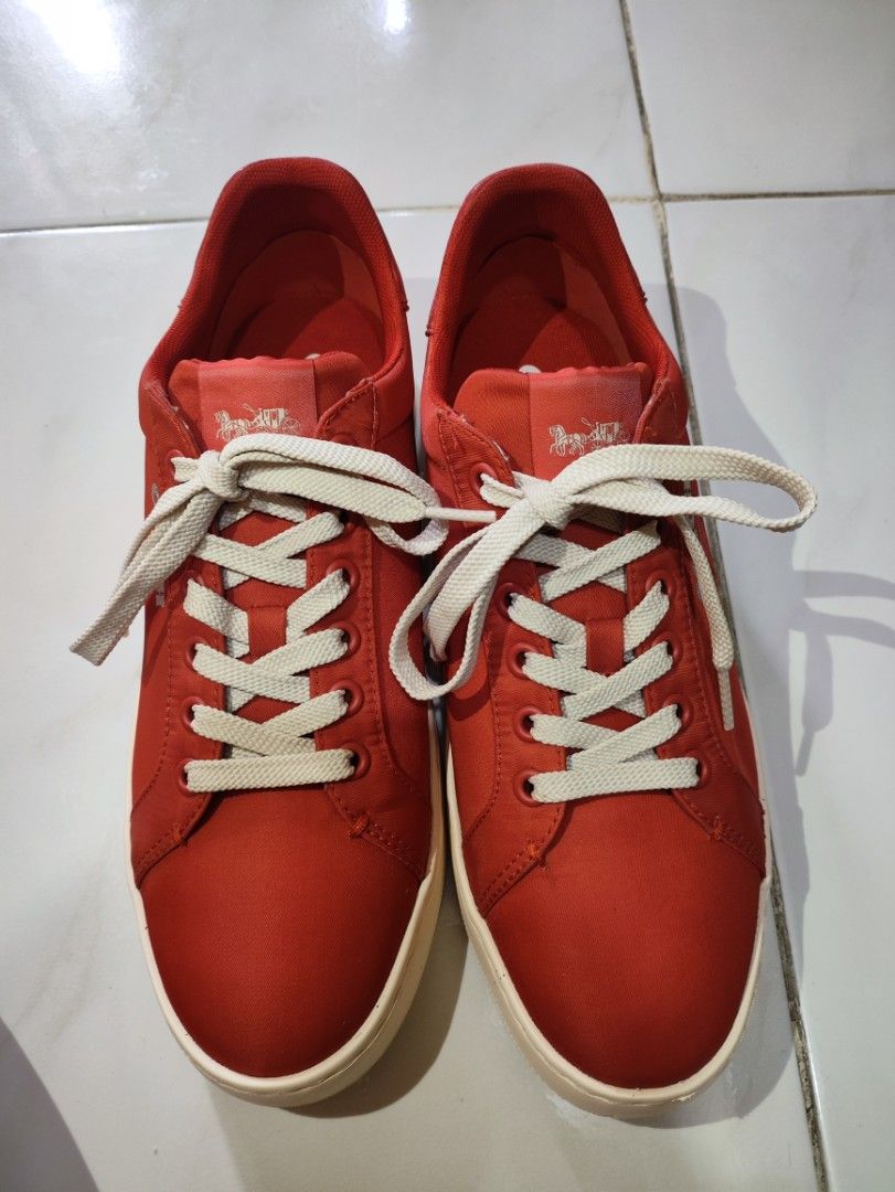 Coach Red Sneakers (Category: Casual Shoes) located in Taguig. Submitted by declutterwithsev (Listing ID 1439594278, Image 1). Description: Authentic Coach Low-Top Sneakers (Burnt Orange / Red) Selling a pair of authentic Coach low-top sneakers in a striking burnt orange/red colorway with clean cream soles. Super stylish, lightweight, and perfect for casual wear. Size & Details: Model Code: CA006 US Size: 9D (Men's) EUR Size: 42 CN Size: 260 (2.5