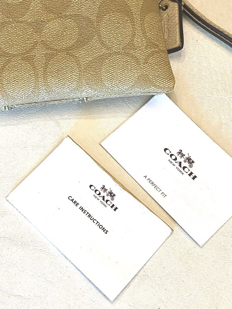 Coach Wristlet (Category: Luxury Bags & Wallets) located in Silang. Submitted by b4wang (Listing ID 1439441970, Image 2). Description: - Authentic Coach wristlet - Wrist strap included - Interior: card slots and main compartment - Includes care instructions card - Condition: wear on center panel and interior stains - Zipper still smooth but really really needs cleaning - Negotiable af.