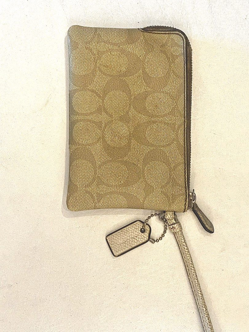 Coach Wristlet (Category: Luxury Bags & Wallets) located in Silang. Submitted by b4wang (Listing ID 1439441970, Image 3). Description: - Authentic Coach wristlet - Wrist strap included - Interior: card slots and main compartment - Includes care instructions card - Condition: wear on center panel and interior stains - Zipper still smooth but really really needs cleaning - Negotiable af.