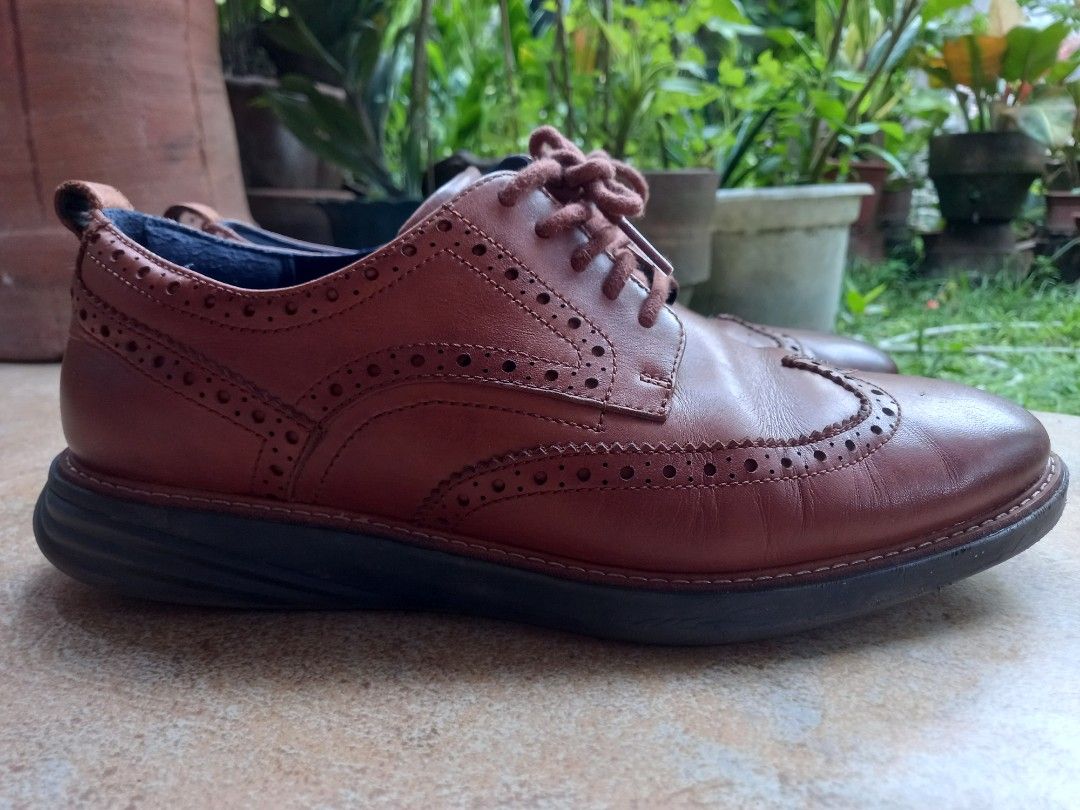 Cole Haan Grandevolution Wingtip Oxford Shoes (Category: Dress Shoes) located in Davao. Submitted by kirk214red-50020 (Listing ID 1439491382, Image 2). Description: - Cole Haan Grandevolution wingtip oxfords - Brown leather - Classic wingtip design with perforations - Size: 9M - Dark sole - Blue interior lining with Cole Haan branding - Lace-up closure - Made in Vietnam.