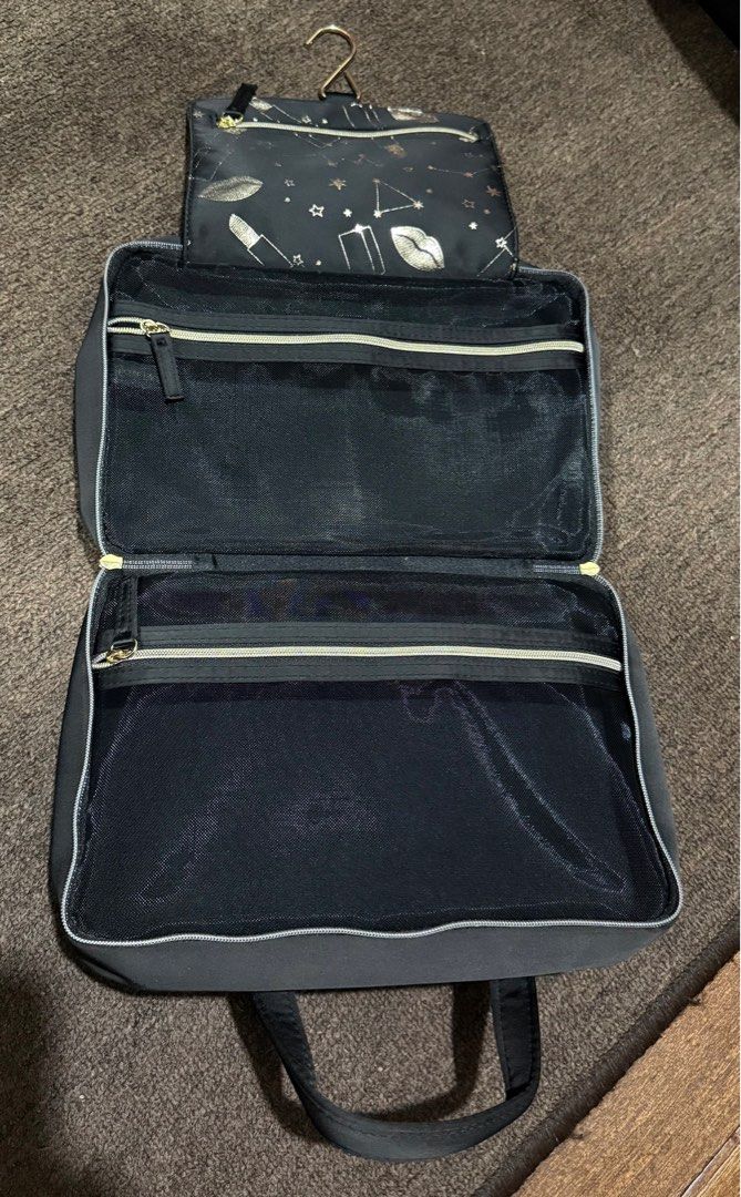 Cosmetic Travel Organizer Bag (Category: Makeup) located in Bulacan. Submitted by rc_retailing (Listing ID 1439554627, Image 3). Description: Estee Lauder - Stylish design with lipstick and constellation embroidery - Convenient handle for easy carrying - Secure zipper closure - Multiple compartments and pockets for organization - Includes a hanging hook for convenient use.