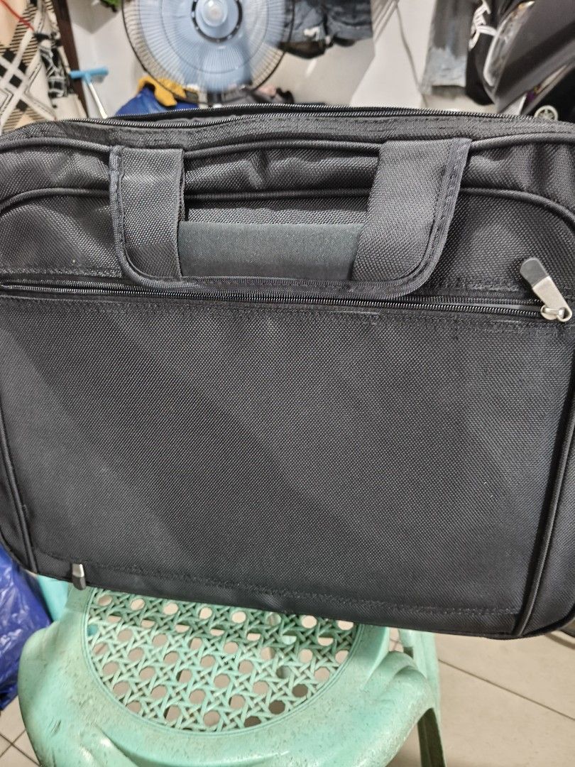 Dell Laptop Bag - Black (Category: Laptop Bags & Sleeves) located in Del Monte. Submitted by anitagalan89774 (Listing ID 1439443838, Image 1). Description: - Black Dell laptop bag - Multiple compartments and zippers - Features a carrying handle - Dell logo on the front - Made of durable fabric - Includes a front pocket and main compartment - Designed for laptops and accessories.