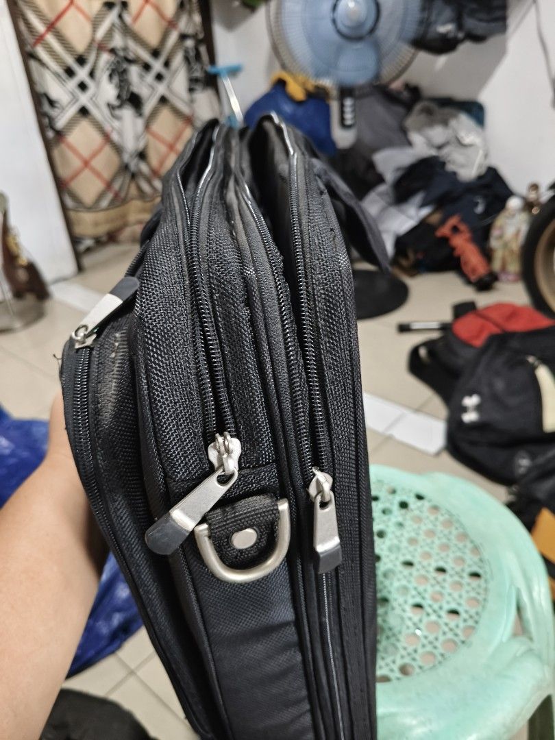 Dell Laptop Bag - Black (Category: Laptop Bags & Sleeves) located in Del Monte. Submitted by anitagalan89774 (Listing ID 1439443838, Image 3). Description: - Black Dell laptop bag - Multiple compartments and zippers - Features a carrying handle - Dell logo on the front - Made of durable fabric - Includes a front pocket and main compartment - Designed for laptops and accessories.