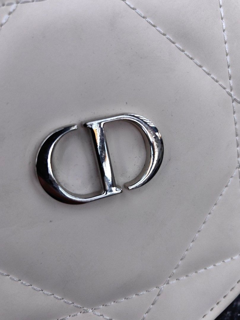 Dior Round Crossbody Bag (Category: Luxury Bags & Wallets) located in Quezon City. Submitted by flat.earther23 (Listing ID 1439489899, Image 3). Description: - Cream-colored, quilted crossbody bag - Features a silver-tone CD logo - Gold chain strap with white leather accents - Dior branded zipper pull - Cream-colored, clean interior.
