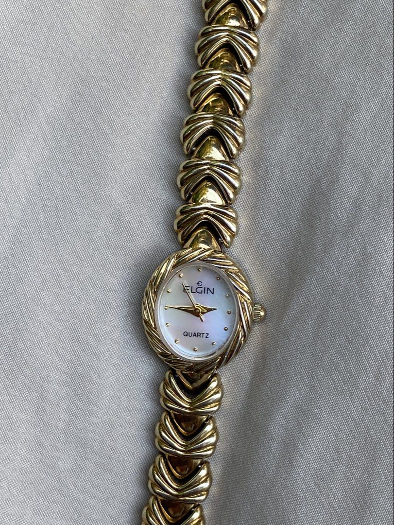 Elgin Quartz Vintage Watch (Category: Women's Watches) located in Makati City. Submitted by imsuli (Listing ID 1439553833, Image 2). Description: ෆ Japan Watch bought for 12k ෆ Gold-toned band ෆ White dial ෆ Round face ෆ Unique link design ෆ Model: EL294 ෆ Heavy Weight ෆ Classic and elegant design.
