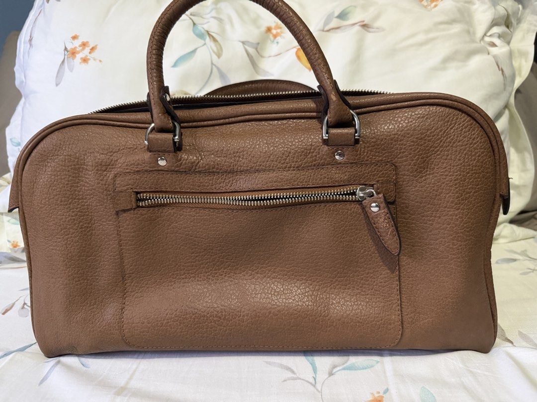FINO Leatherware Brown Handbag (Category: Luxury Bags & Wallets) located in Paranaque City. Submitted by riannep (Listing ID 1439475856, Image 2). Description: - Brand: FINO Leatherware - Material: Genuine brown leather - Design: Top handle handbag - Closure: Zipper closure for main compartment and exterior pocket - Features: Multiple interior compartments for organization - Shape: Rectangular - Exterior: Textured leather finish - Details: Metal 