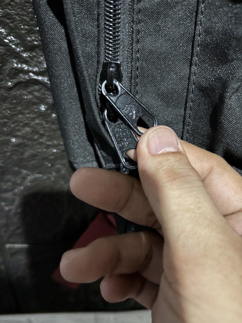 Fjallraven Kanken Backpack (Category: Backpacks) located in Lopez. Submitted by thrift.ni.roms22 (Listing ID 1439559793, Image 3). Description: Black Fjallraven Kanken backpack with red straps. Features a front pocket and a main compartment with a zipper closure. The Fjallraven logo is visible on the front. Includes adjustable shoulder straps and a top handle. The backpack has a classic design..