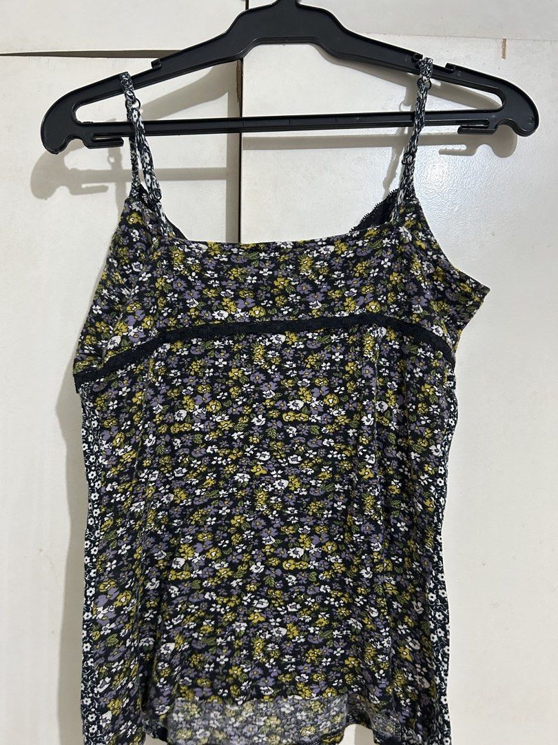 Floral Camisole (Category: Sleeveless) located in Quezon City. Submitted by samthingsshop (Listing ID 1439564474, Image 2). Description: - Floral print camisole - Black lace trim - Adjustable spaghetti straps - V-neckline - Mixed floral patterns - Lightweight material - Suitable for layering.