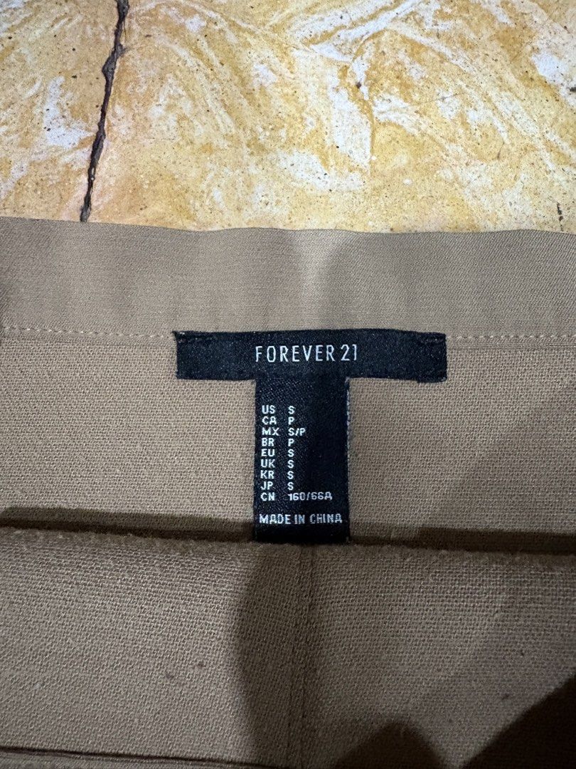 Forever 21 Beige Skirt - Size S (Category: Skirts) located in Makati City. Submitted by goodfindsonly (Listing ID 1439527724, Image 2). Description: - Forever 21 beige skirt - Size: S - Features a front slit - Made in China - Classic design - Versatile for various occasions - Easy to pair with different tops and shoes.