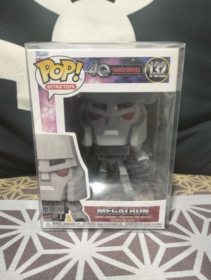 Funko Pop! Retro Toys Transformers Megatron #132 (Category: Figurines & Statues) located in Subic. Submitted by sandir (Listing ID 1439565482, Image 1). Description: Funko Pop! Retro Toys figure of Megatron from the Transformers series. This collectible figure is number 132 in the series and celebrates the 40th anniversary of Transformers. The figure is in its original packaging. The box features the Funko Pop! Retro Toys logo and the Transformer