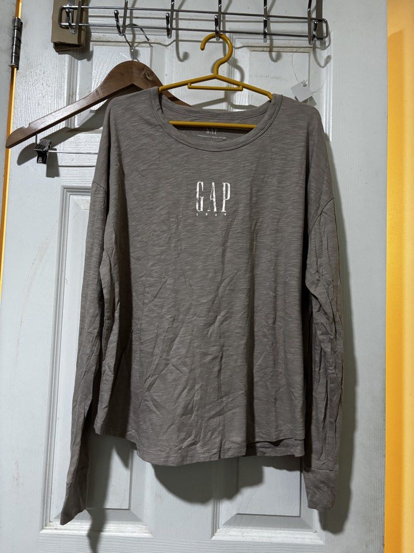 GAP Long Sleeve Shirt (Category: Longsleeves) located in Manila. Submitted by joahnaf (Listing ID 1439476272, Image 1). Description: - GAP long-sleeved shirt - Features the GAP logo - Crew neck design - Relaxed fit for comfort - Versatile neutral color - Perfect for casual outfits.