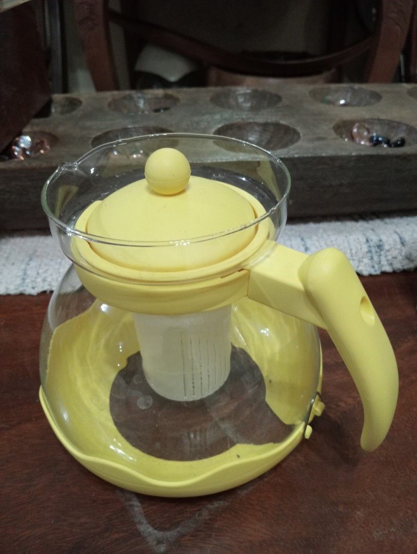Glass Teapot with Infuser (Category: Coffee & Tea Tableware) located in Makati City. Submitted by YSL80022 (Listing ID 1439505256, Image 2). Description: - Glass teapot with yellow lid, handle, and base - Features a built-in infuser - Comes with original box - Designed for serving tea - Made of glass and plastic - Never used, got as a gift - selling for Php450, negotiable.