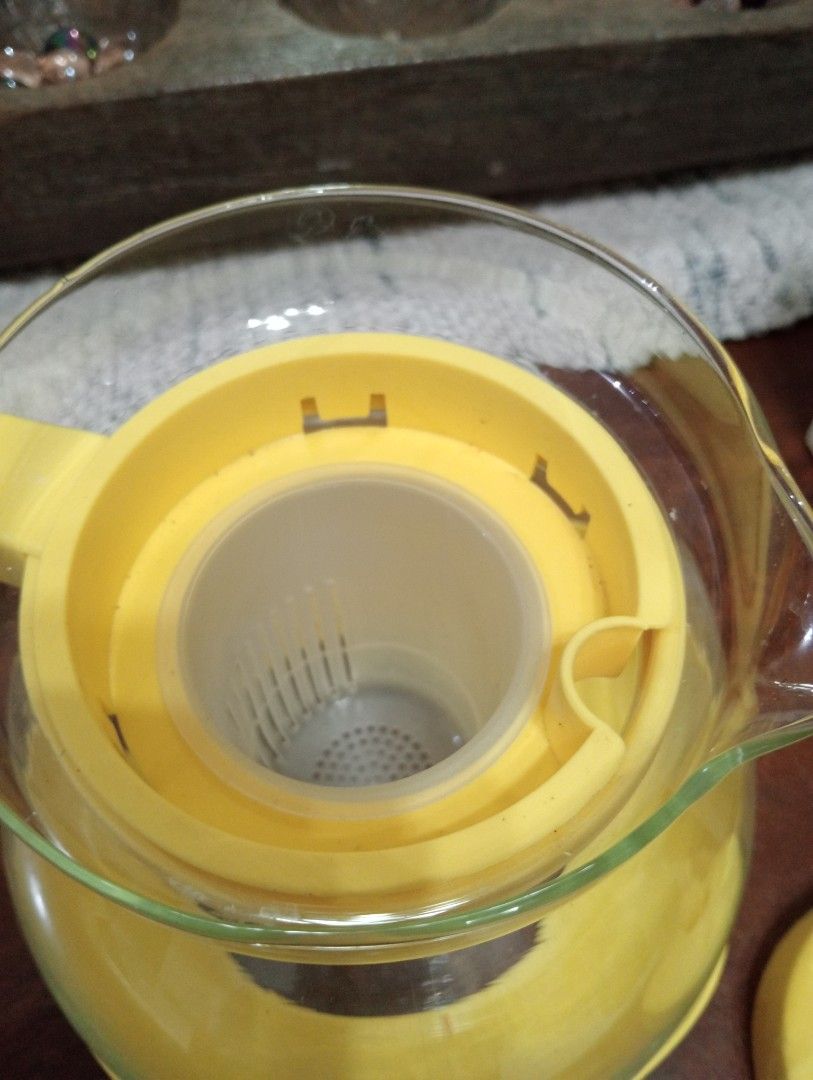 Glass Teapot with Infuser (Category: Coffee & Tea Tableware) located in Makati City. Submitted by YSL80022 (Listing ID 1439505256, Image 3). Description: - Glass teapot with yellow lid, handle, and base - Features a built-in infuser - Comes with original box - Designed for serving tea - Made of glass and plastic - Never used, got as a gift - selling for Php450, negotiable.