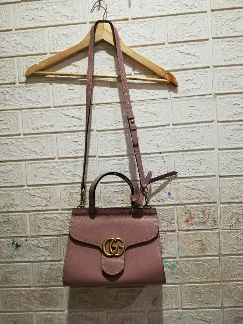 Gucci GG Marmont Top Handle Bag (Category: Luxury Bags & Wallets) located in Rizal. Submitted by tiangarcia02 (Listing ID 1439567642, Image 2). Description: - Authentic Gucci handbag - Light pink textured leather - Top handle and detachable shoulder strap - Flap closure with GG logo - Gold-toned hardware - Interior tag: "Gucci made in Italy".