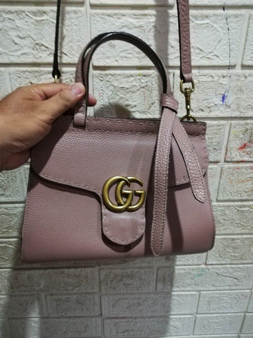 Gucci GG Marmont Top Handle Bag (Category: Luxury Bags & Wallets) located in Rizal. Submitted by tiangarcia02 (Listing ID 1439567642, Image 1). Description: - Authentic Gucci handbag - Light pink textured leather - Top handle and detachable shoulder strap - Flap closure with GG logo - Gold-toned hardware - Interior tag: "Gucci made in Italy".