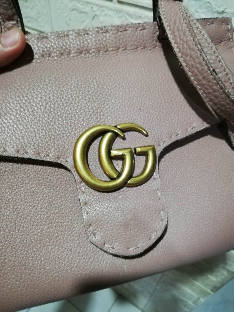 Gucci GG Marmont Top Handle Bag (Category: Luxury Bags & Wallets) located in Rizal. Submitted by tiangarcia02 (Listing ID 1439567642, Image 3). Description: - Authentic Gucci handbag - Light pink textured leather - Top handle and detachable shoulder strap - Flap closure with GG logo - Gold-toned hardware - Interior tag: "Gucci made in Italy".
