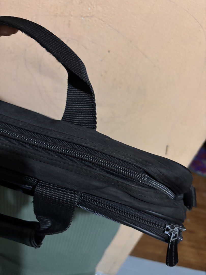 HP Laptop Bag (Category: Laptop Bags & Sleeves) located in San Fernando. Submitted by ladychinita07 (Listing ID 1439452565, Image 3). Description: - Black HP laptop bag - Multiple compartments for organization - Includes handle and shoulder strap - Features front pocket with HP logo - Durable material - Visible zippers on sides and top.