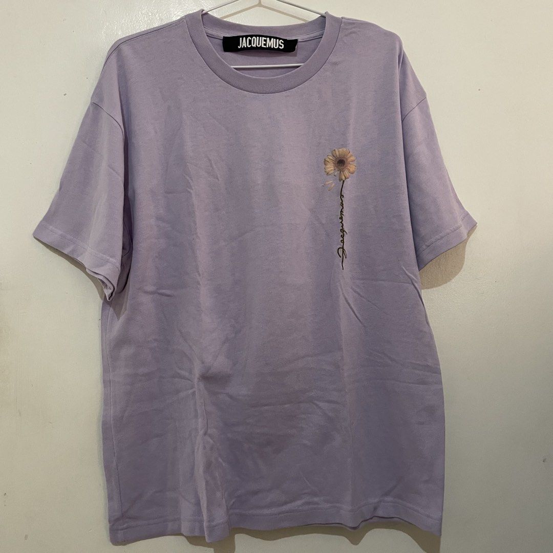 JACQUEMUS Sunflower T-shirt (Category: Shirts) located in Leyte. Submitted by byebabies (Listing ID 1439563794, Image 1). Description: Lavender Jacquemus T-shirt featuring a sunflower graphic on the front. It has a crew neck and short sleeves. The brand label is visible on the neck and the size tag indicates size S. Made in Portugal. All items NEGOTIABLE for SAME DAY PAYMENT Do not offer 50% from its price Everything priced below 500 can be sold 