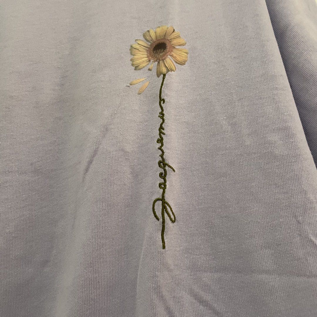 JACQUEMUS Sunflower T-shirt (Category: Shirts) located in Leyte. Submitted by byebabies (Listing ID 1439563794, Image 2). Description: Lavender Jacquemus T-shirt featuring a sunflower graphic on the front. It has a crew neck and short sleeves. The brand label is visible on the neck and the size tag indicates size S. Made in Portugal. All items NEGOTIABLE for SAME DAY PAYMENT Do not offer 50% from its price Everything priced below 500 can be sold 