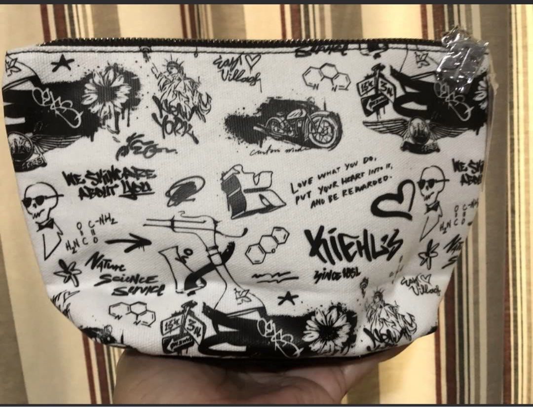 Kiehl's Cosmetic Pouch (Category: Purses & Pouches) located in Calapan. Submitted by shakalak (Listing ID 1439465504, Image 3). Description: - Authentic Kiehl's cosmetic pouch. - Features a white background with black and blue graphics. - Includes zipper closure. - Adorned with Kiehl's logo, hearts, and motorcycle illustrations. - Made of a canvas-like material. - Ideal for storing makeup and small essentials. -Fr Belgium .