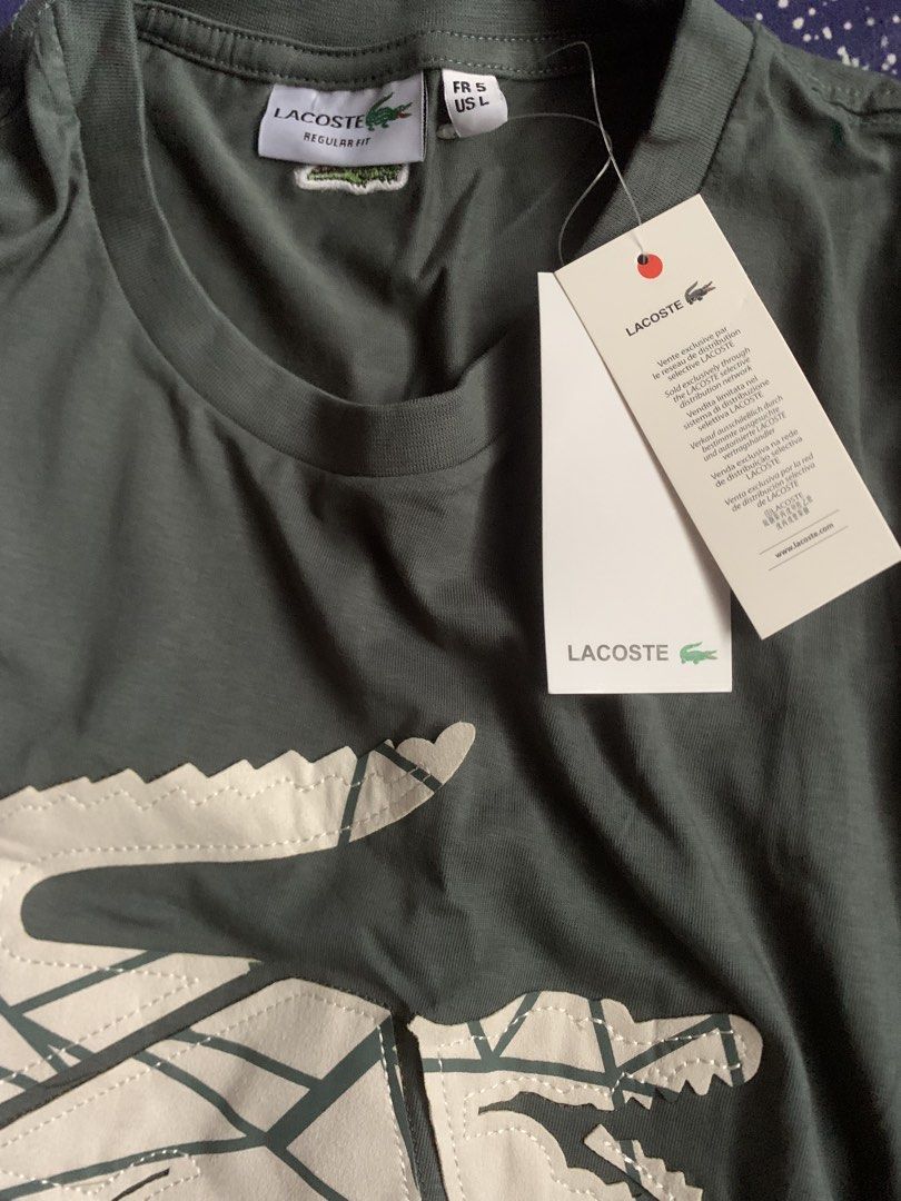 Lacoste Regular Fit T-shirt (Category: Tshirts & Polo Shirts ) located in Manila. Submitted by eriel_dion (Listing ID 1439482489, Image 2). Description: - Authentic Lacoste T-shirt - Features the classic crocodile logo - Comfortable regular fit - Crew neck design - Solid color - Lacoste logo on the back - Brand new with original tags - Made in Bangladesh.