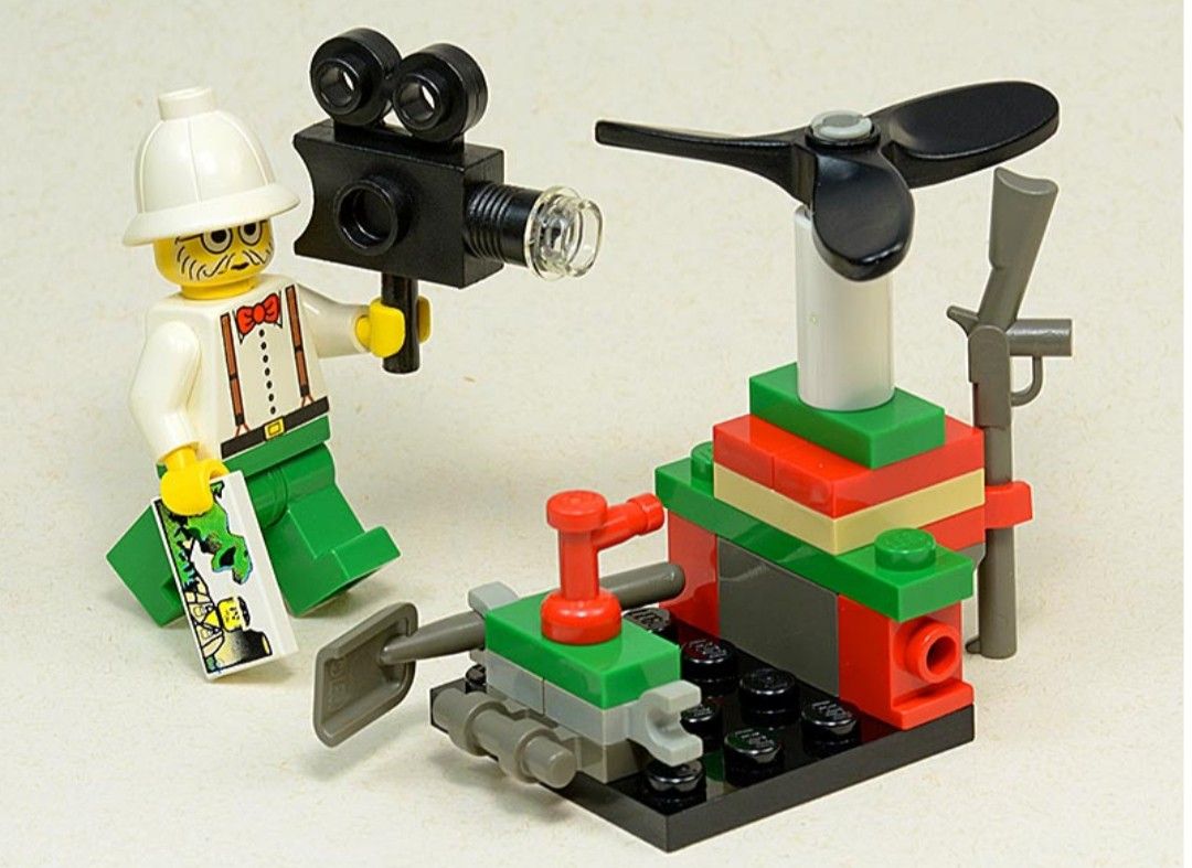 Lego Vintage Adventurers Set Microcopter (Category: Lego & Building Sets) located in Quezon City. Submitted by vincentgo2024 (Listing ID 1439517975, Image 2). Description: - LEGO set with adventurer minifigure - Includes camera and small aircraft - Features propeller, red and green structure, and vehicle - Minifigure details: white hat, white shirt with suspenders, green pants.