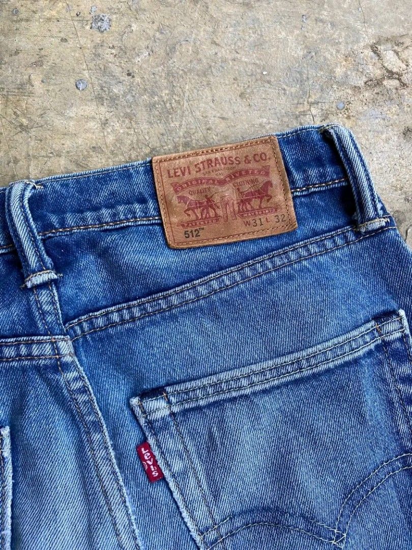 Levi's 512 Slim Taper Jeans (Category: Jeans) located in Manila. Submitted by thebrothrift (Listing ID 1439563528, Image 1). Description: - Levi's 512 Slim Taper Jeans - Size: W31L32 - Classic blue wash - Button closure - Features the iconic Levi's red tab - Slim fit - Tapered leg opening - Minor dark marks on the back.