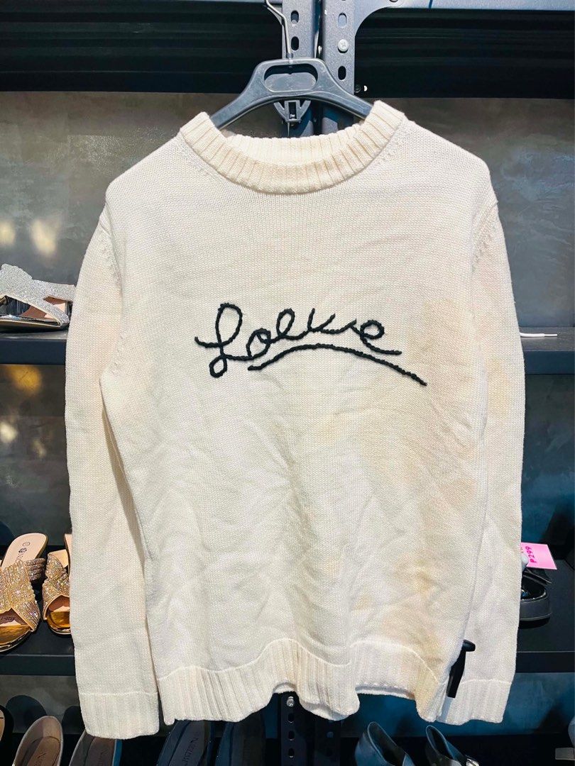 Loewe Embroidered Cotton Sweater - Ecru (Category: Coats, Jackets and Outerwear) located in Manila. Submitted by jaspermack50866 (Listing ID 1439587339, Image 2). Description: - Loewe ecru cotton sweater - Crew neck design - Ribbed trims and cuffs - Made in Italy - Mid-weight cotton - Hand-stitched Loewe logo - Size tag visible in images - Dry clean only.