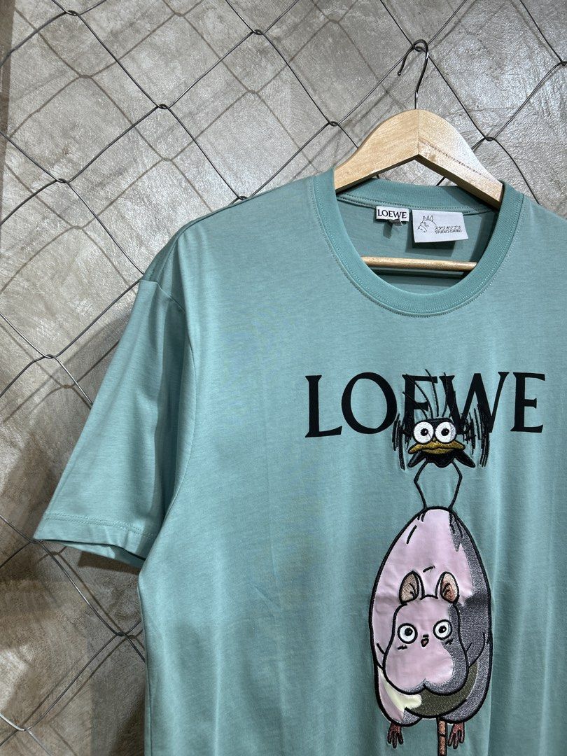 Loewe x Spirited Away T-shirt (Category: Tshirts & Polo Shirts ) located in Manila. Submitted by ardobe.mnl (Listing ID 1439465374, Image 2). Description: Loewe x Studio Ghibli Green Tee. Size: Large Dimes: 21x28 Condition: Good asnew Flaw: None! Dm to purchase! 📥.