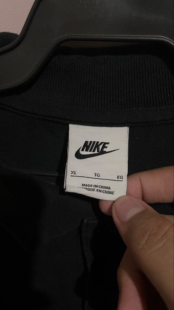 Nike Polo Shirt - Black - XL (Category: Tshirts & Polo Shirts ) located in Dinalupihan. Submitted by ash1hara_thrift. (Listing ID 1439429340, Image 2). Description: - Black Nike polo shirt - Size: XL - Nike logo on chest - Made in China - Includes care instructions - Classic polo collar and button closure.