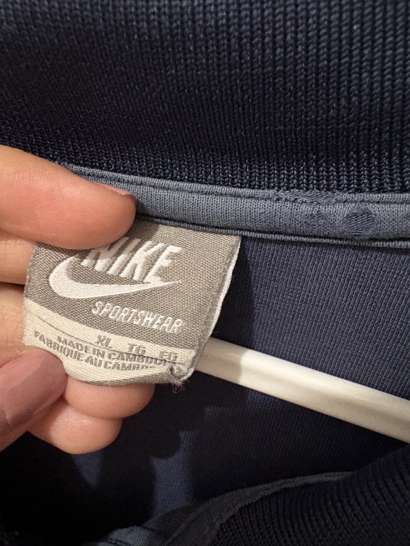 Nike Sportswear Track Jacket XL (Category: Coats, Jackets and Outerwear) located in Muntinlupa City. Submitted by take2mnl (Listing ID 1439529328, Image 2). Description: - Navy blue Nike track jacket - Red stripe accents - Size: XL - Full-length zipper - Two side pockets - Embroidered Nike logo - Collar and long sleeves.