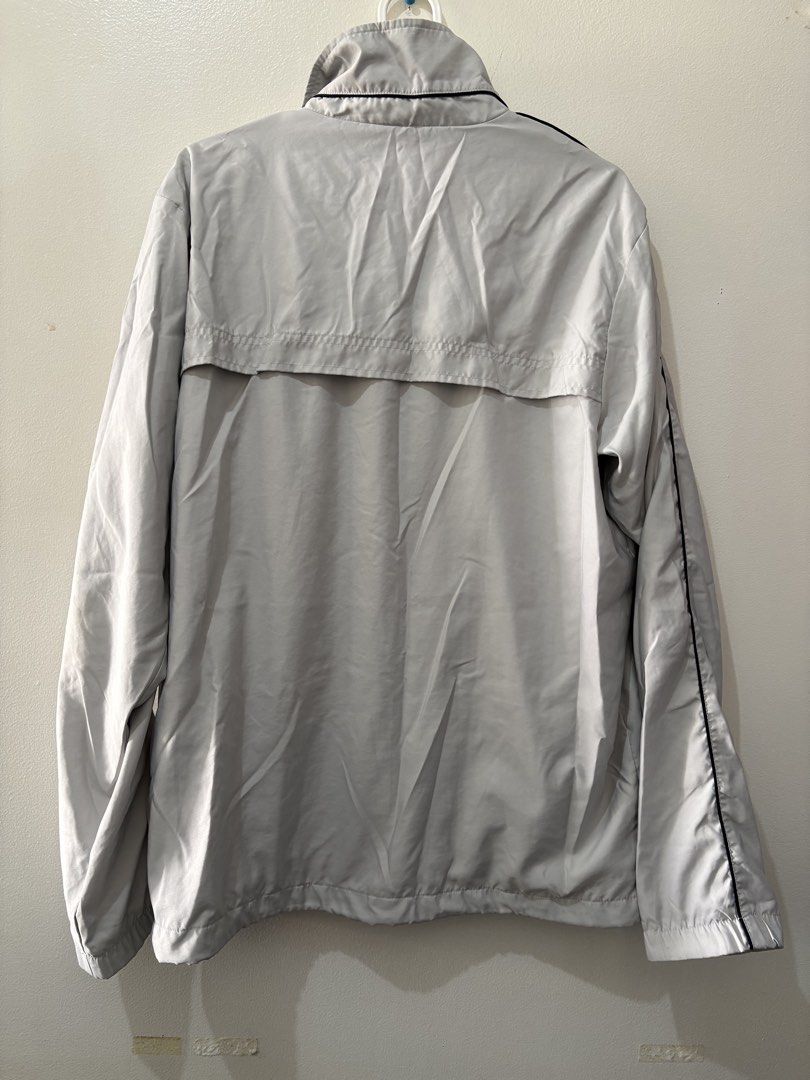 Nike Sportswear Track Jacket XL (Category: Coats, Jackets and Outerwear) located in Muntinlupa City. Submitted by take2mnl (Listing ID 1439530171, Image 2). Description: - Nike Sportswear track jacket - Light grey color - Red and black stripe design - Small Nike logo - Full zip closure - Two front pockets - Black trim - Made in China.