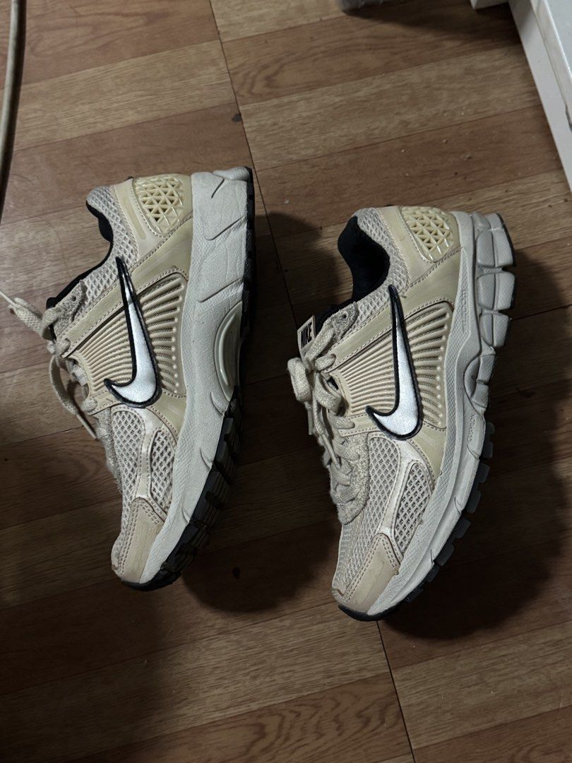 Nike Zoom Vomero 5 Sneakers (Category: Sneakers) located in Manila. Submitted by welllovedstuff03 (Listing ID 1439605459, Image 3). Description: Nike Zoom Vomero 5 sneakers in a cream and black colorway. Features the Nike swoosh on the sides. The shoes have mesh detailing and a cushioned sole. The tongue of the shoe has the Nike logo and the words "Vomero 5"..